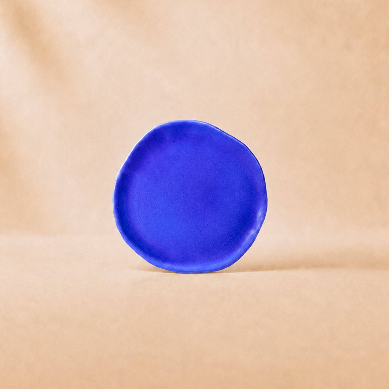 Blue ceramic plate on a beige background