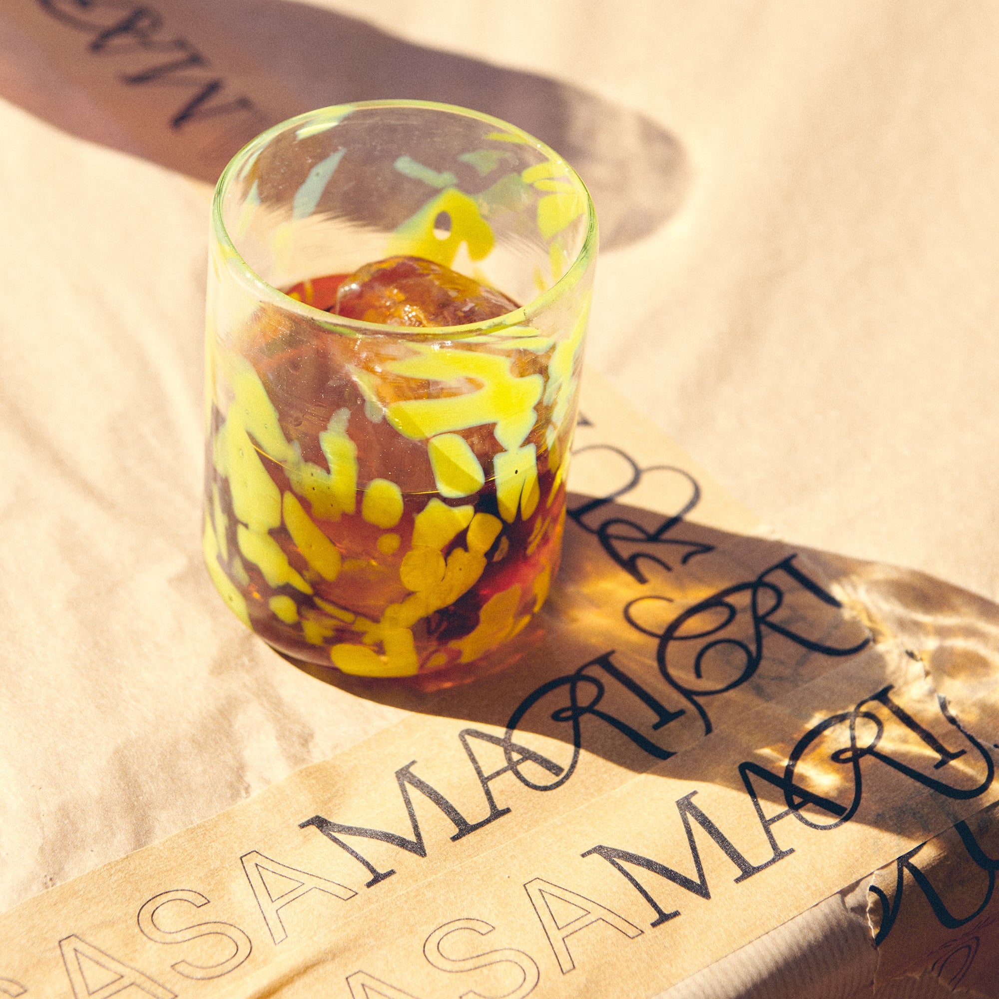 Colorful glass on a textured surface with casa maricruz - lifestyle