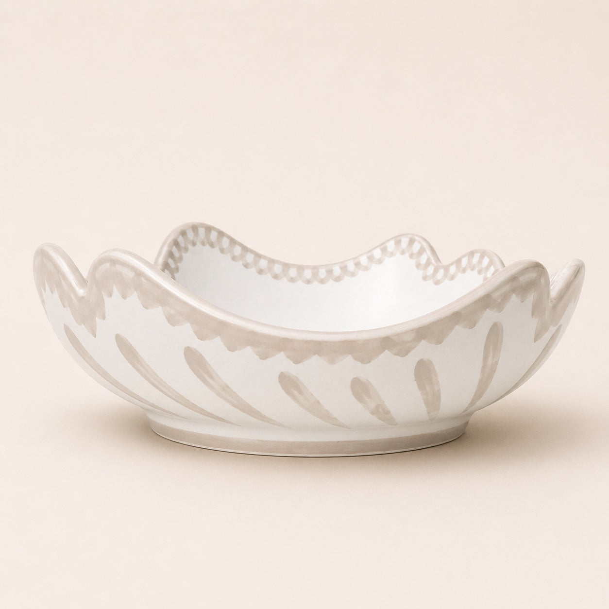 Decorative ceramic bowl with intricate patterns on a beige background