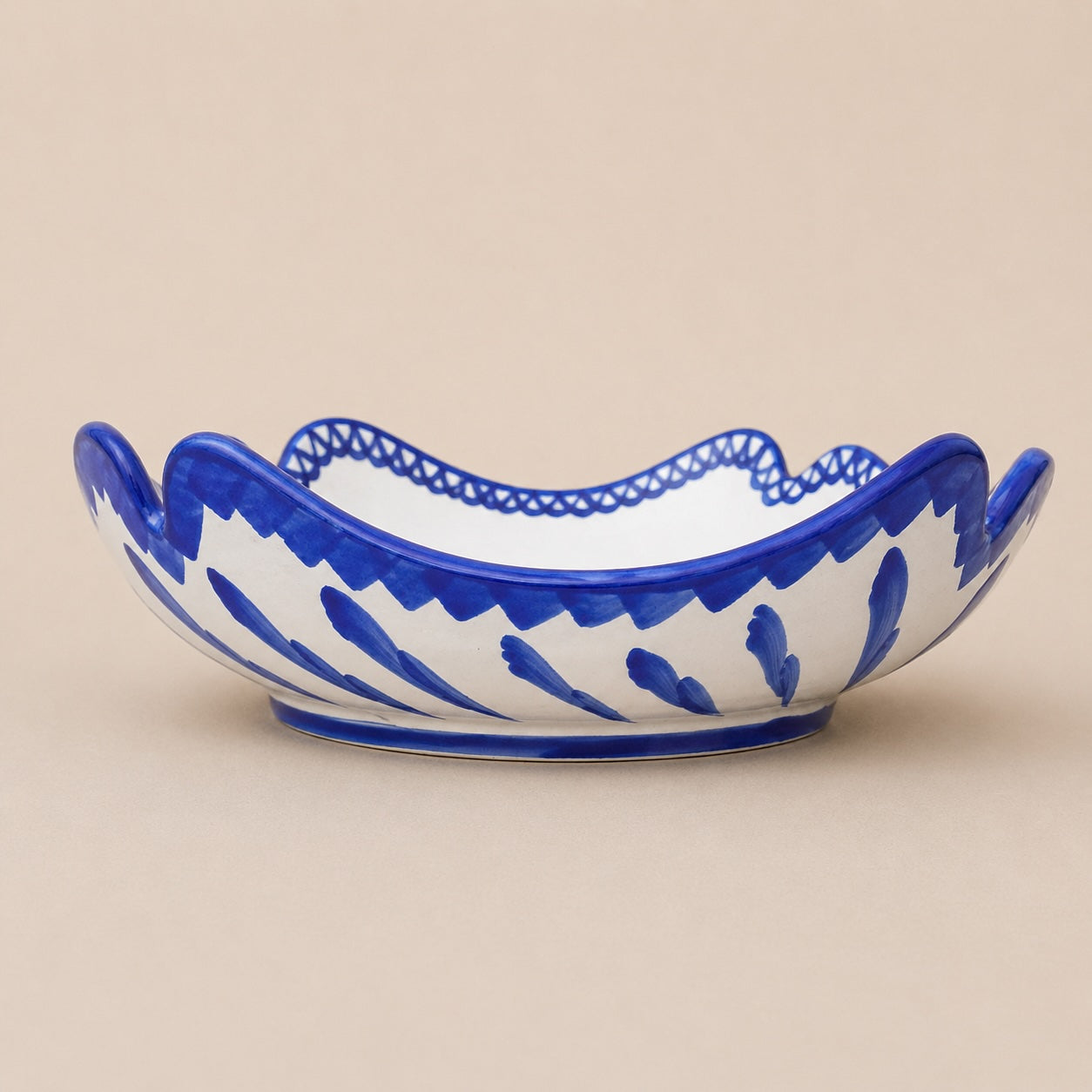 Ceramic bowl with blue and white pattern on a beige background
