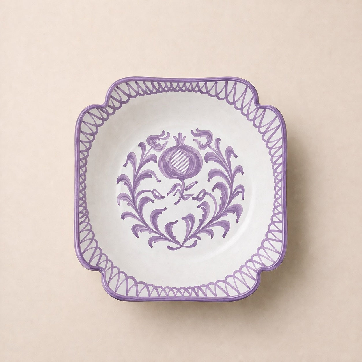 Decorative plate with purple floral design on a beige background