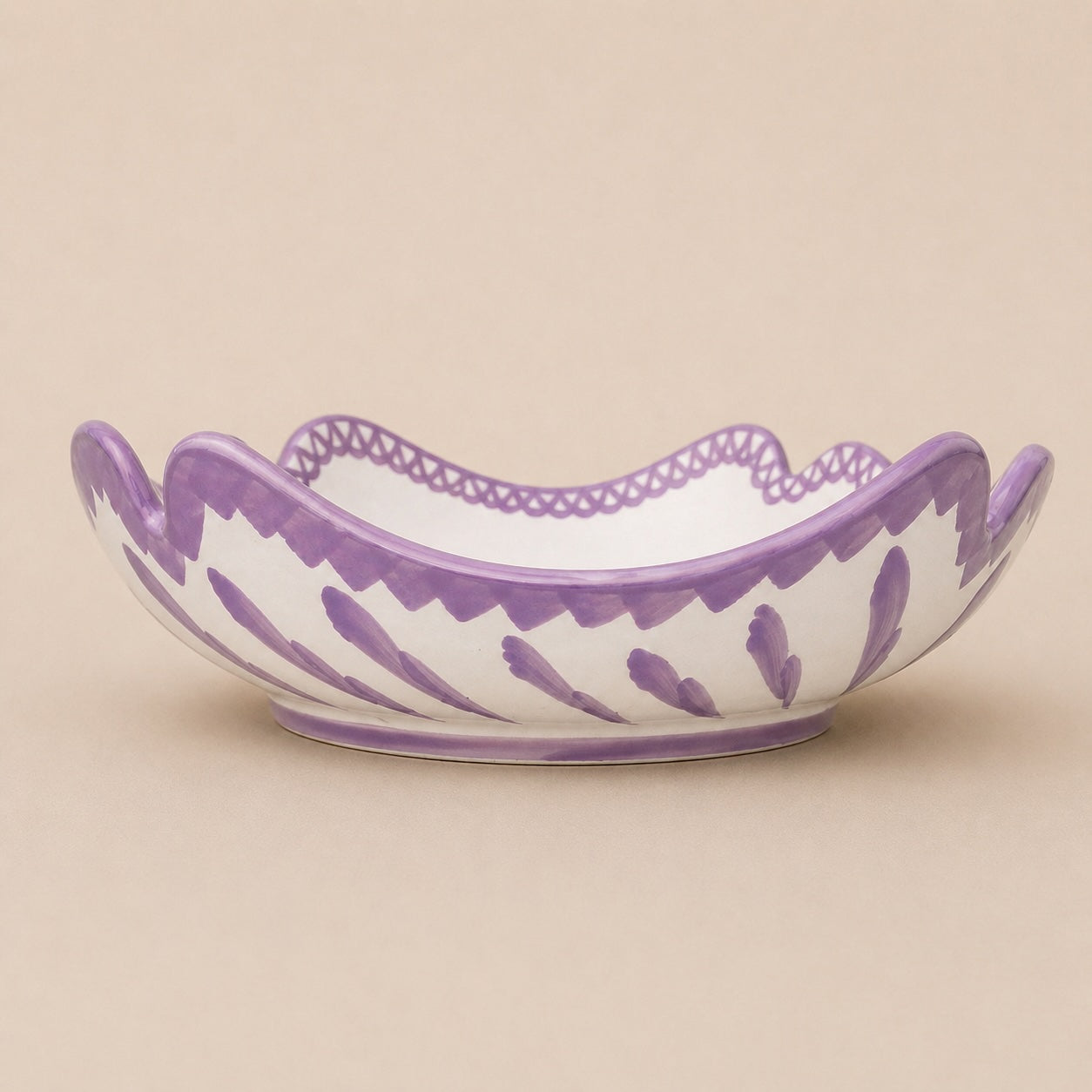 Decorative bowl with purple and white pattern on a beige background