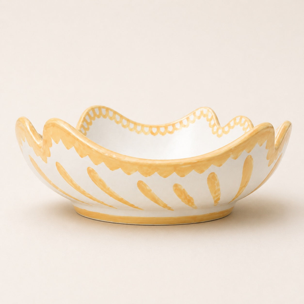 Decorative ceramic bowl with yellow patterns on a beige background