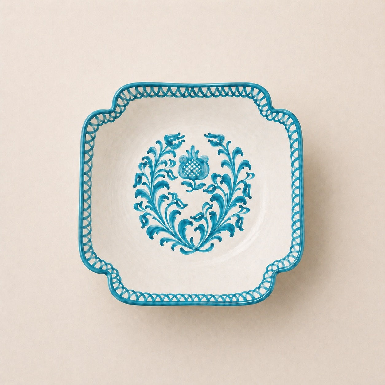 Decorative plate with blue floral pattern on a beige background