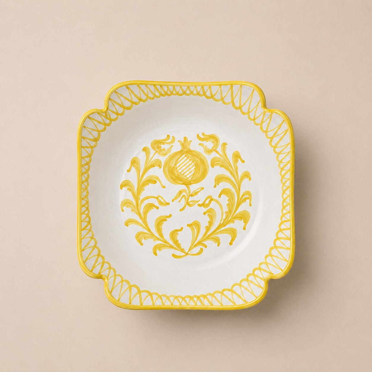 Decorative plate with yellow floral design on a beige background