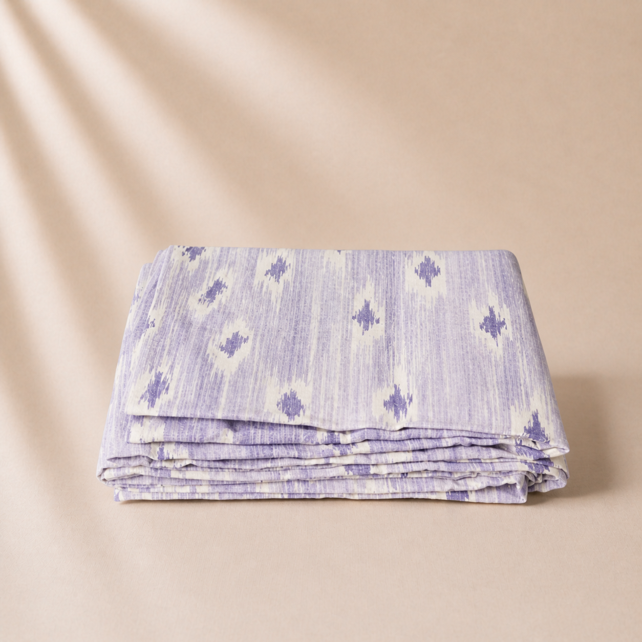 Folded fabric with a subtle pattern on a beige background
