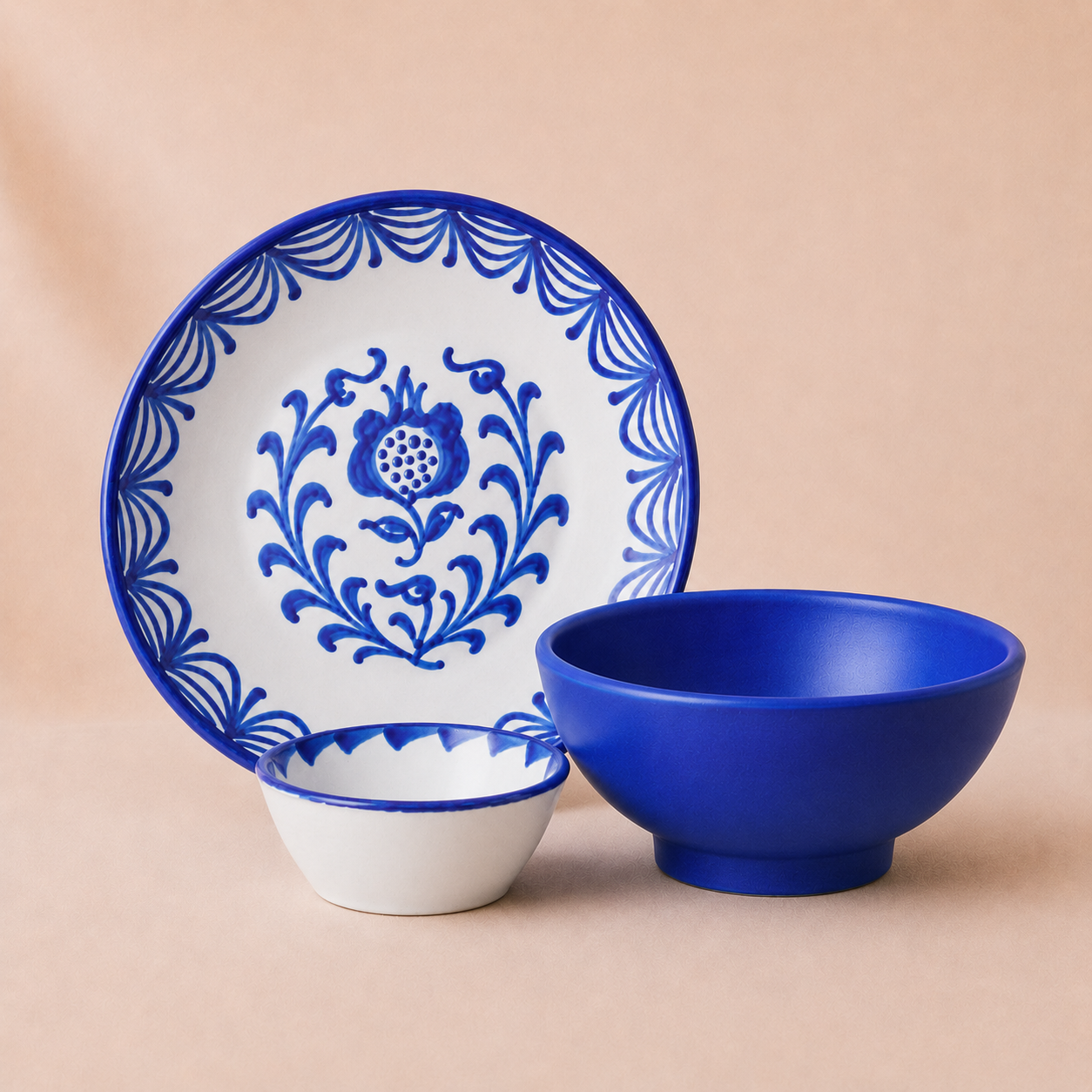 Set of blue and white ceramic dishes with floral patterns on a beige background