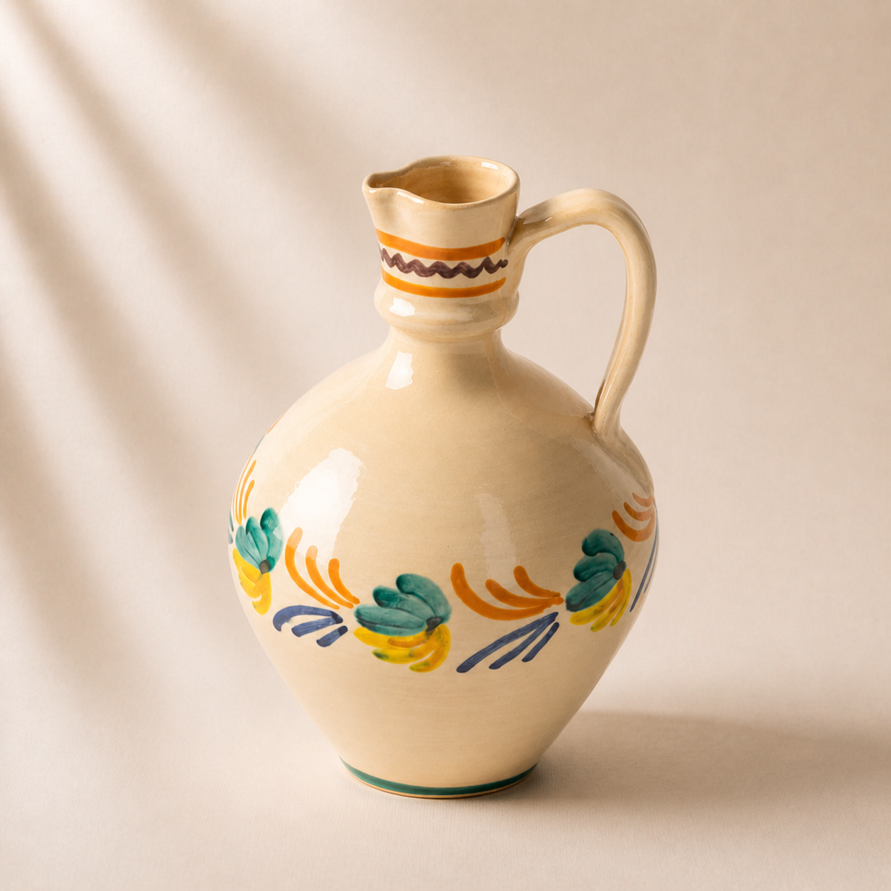 Decorative ceramic pitcher with colorful patterns on a beige background