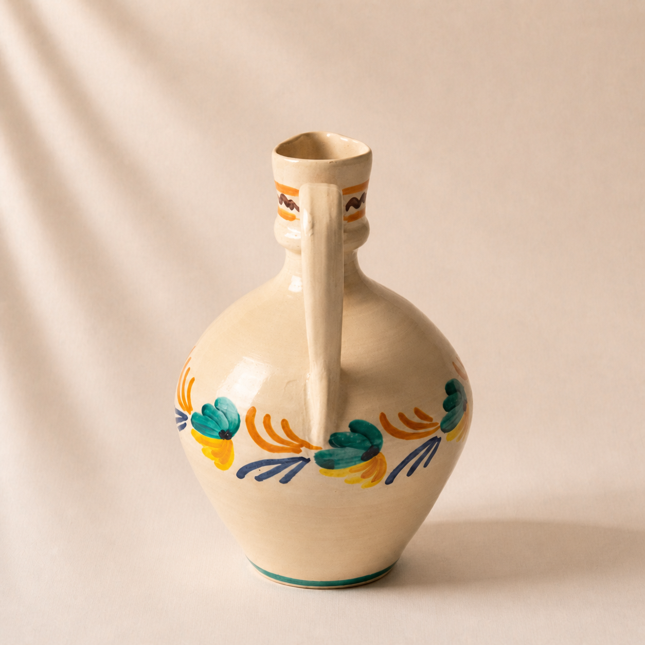 Ceramic vase with decorative patterns on a beige background
