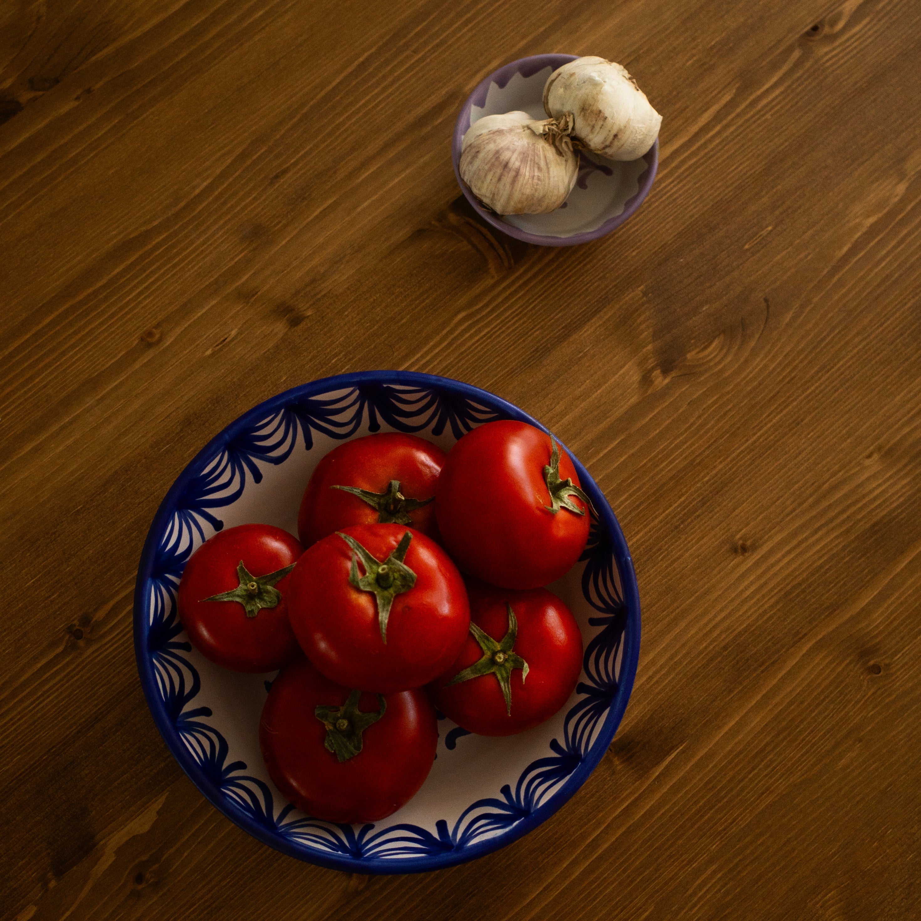 Blue plate with tomatoes on a wooden table -lifestyle