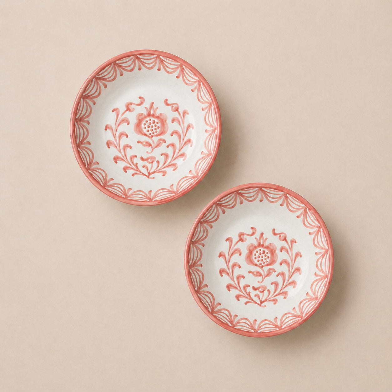 Two decorative plates with floral patterns on a beige background
