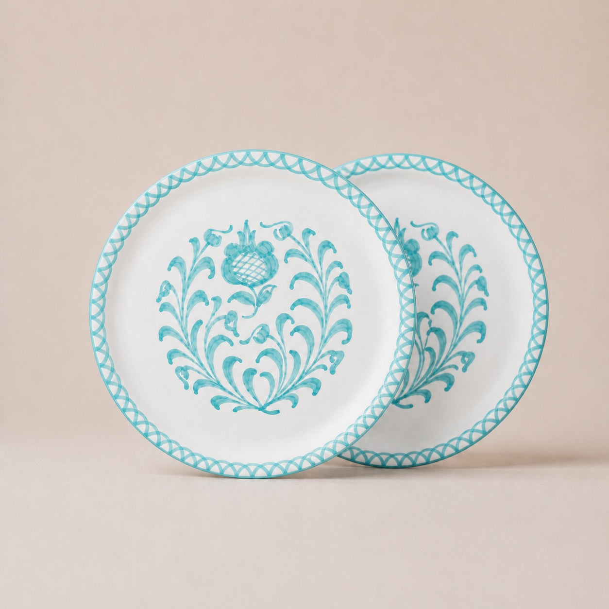 Two white plates with blue floral patterns on a beige background
