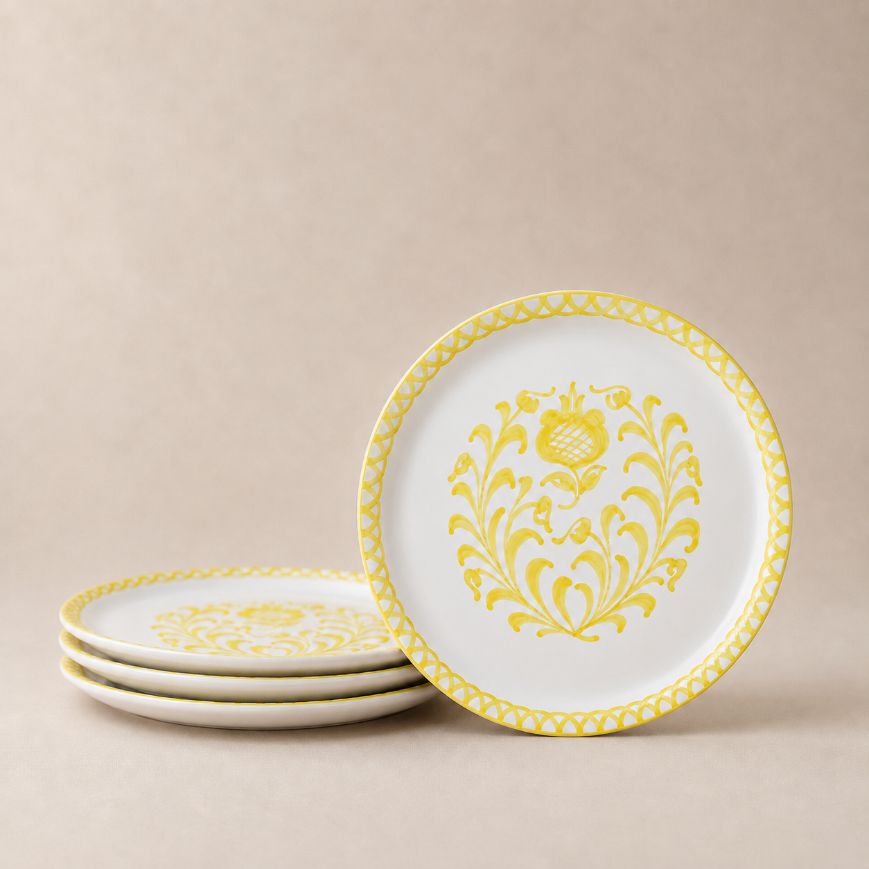 Set of white plates with yellow floral patterns on a beige background