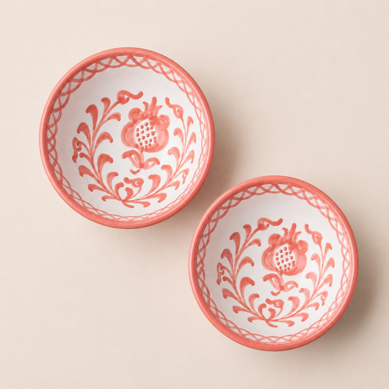 Two decorative bowls with floral patterns on a beige background