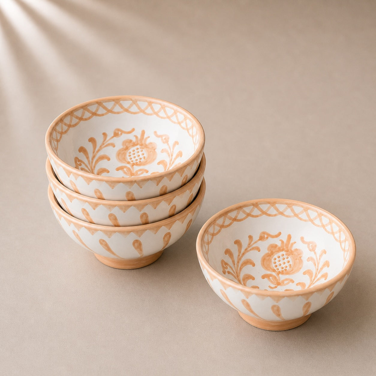 Set of ceramic bowls with floral patterns on a beige background