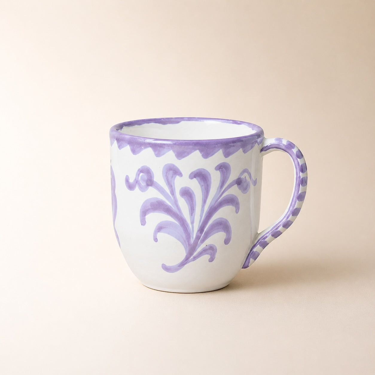 White mug with purple floral patterns on a beige background