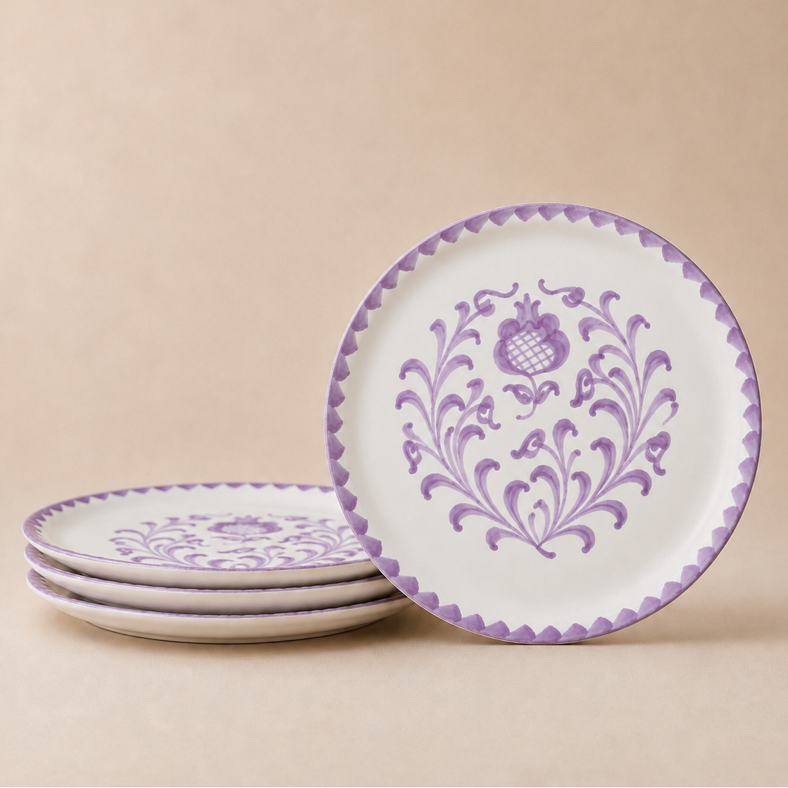 Set of ceramic plates with purple floral patterns on a beige background