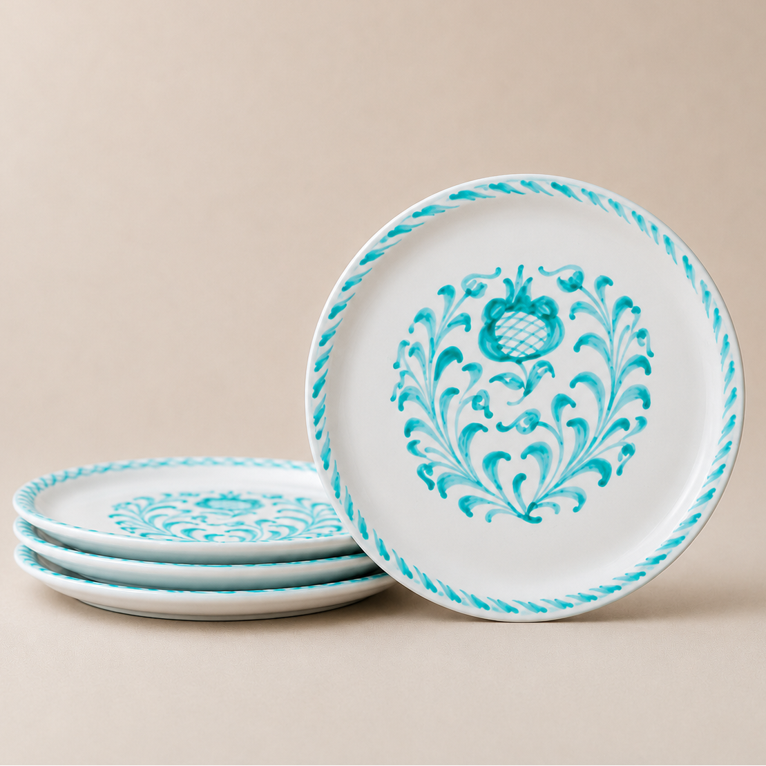 Set of three decorative plates with turquoise patterns on a beige background