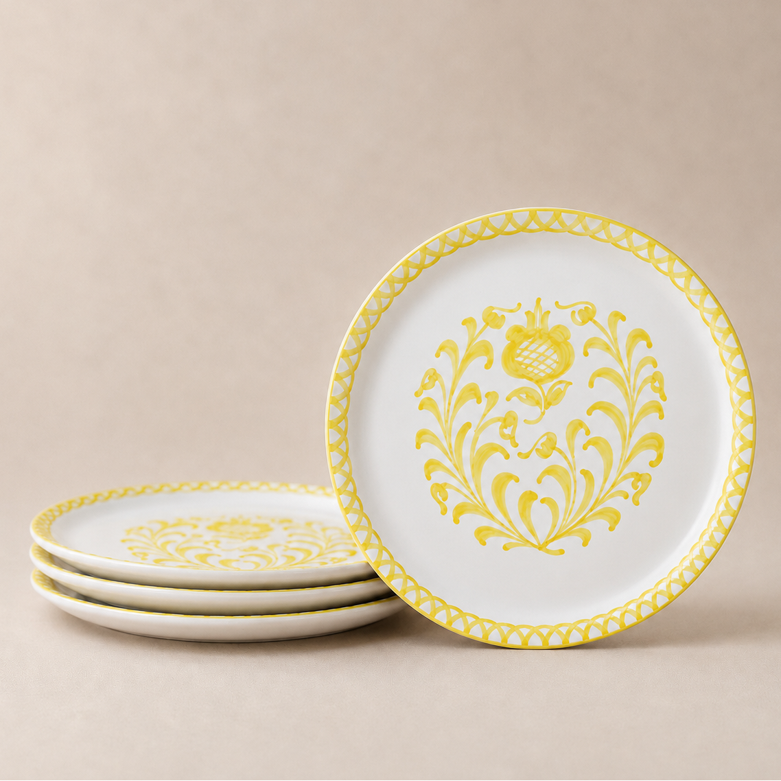 Set of white plates with yellow floral patterns on a beige background