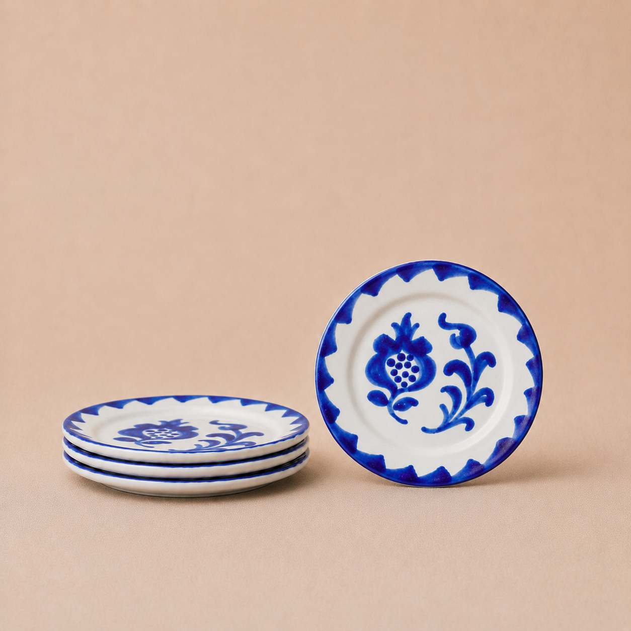 Set of blue and white ceramic plates on a beige background