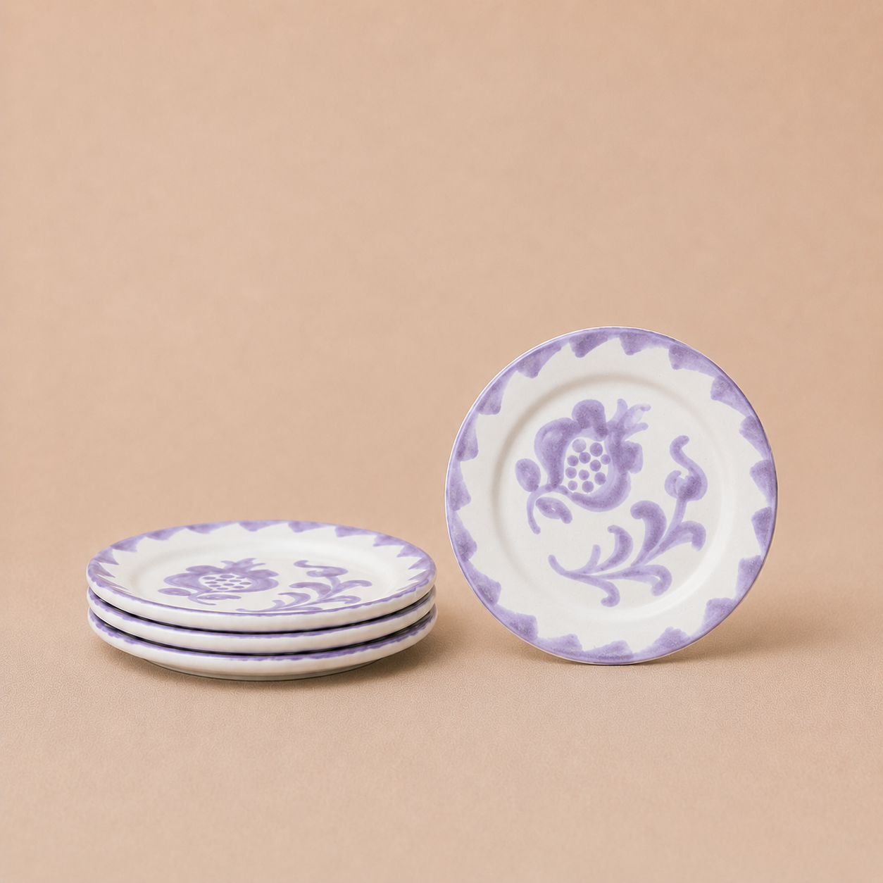 Set of ceramic plates with purple floral design on a beige background