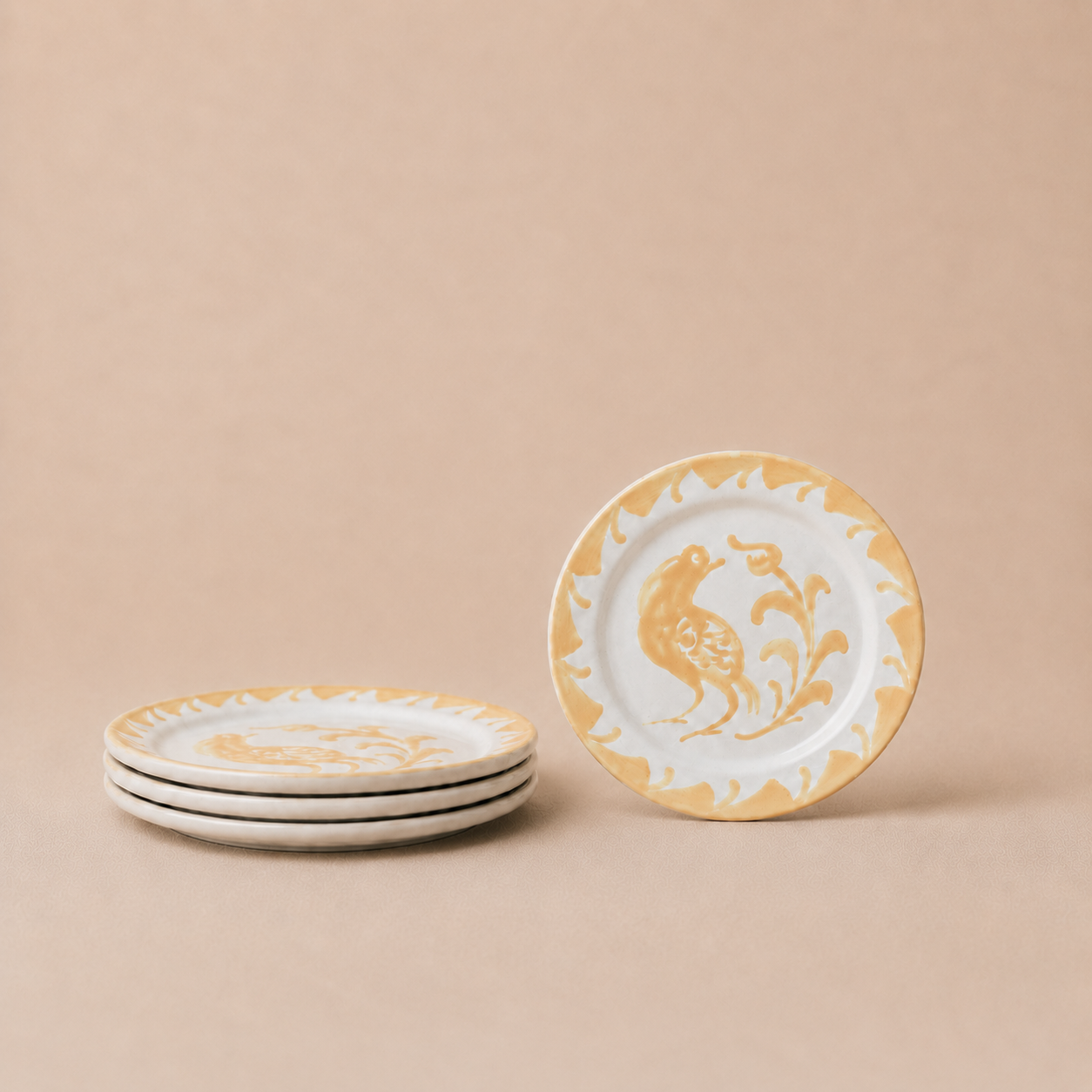 Set of ceramic plates with gold and white design on a beige background