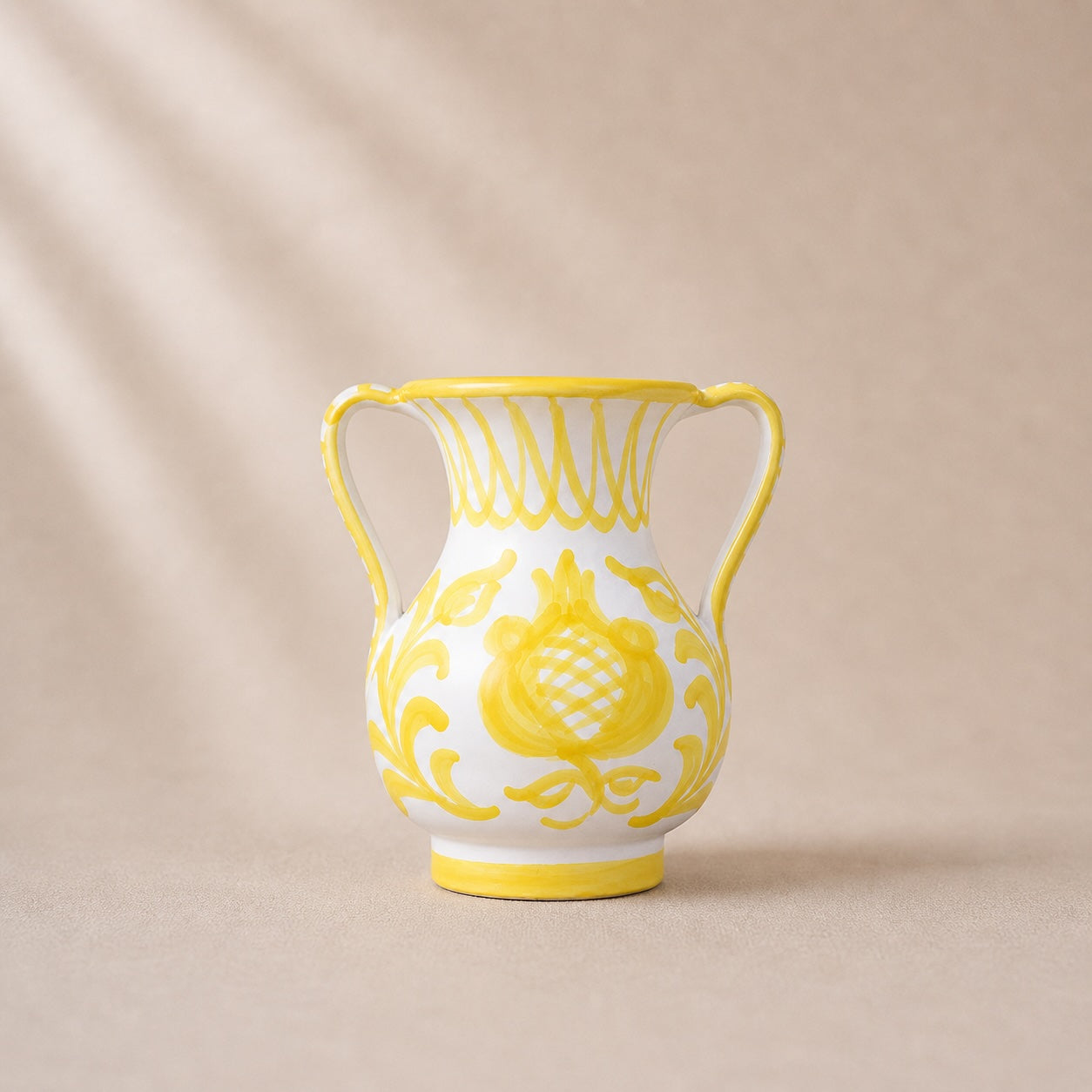 Decorative vase with yellow floral patterns on a beige background