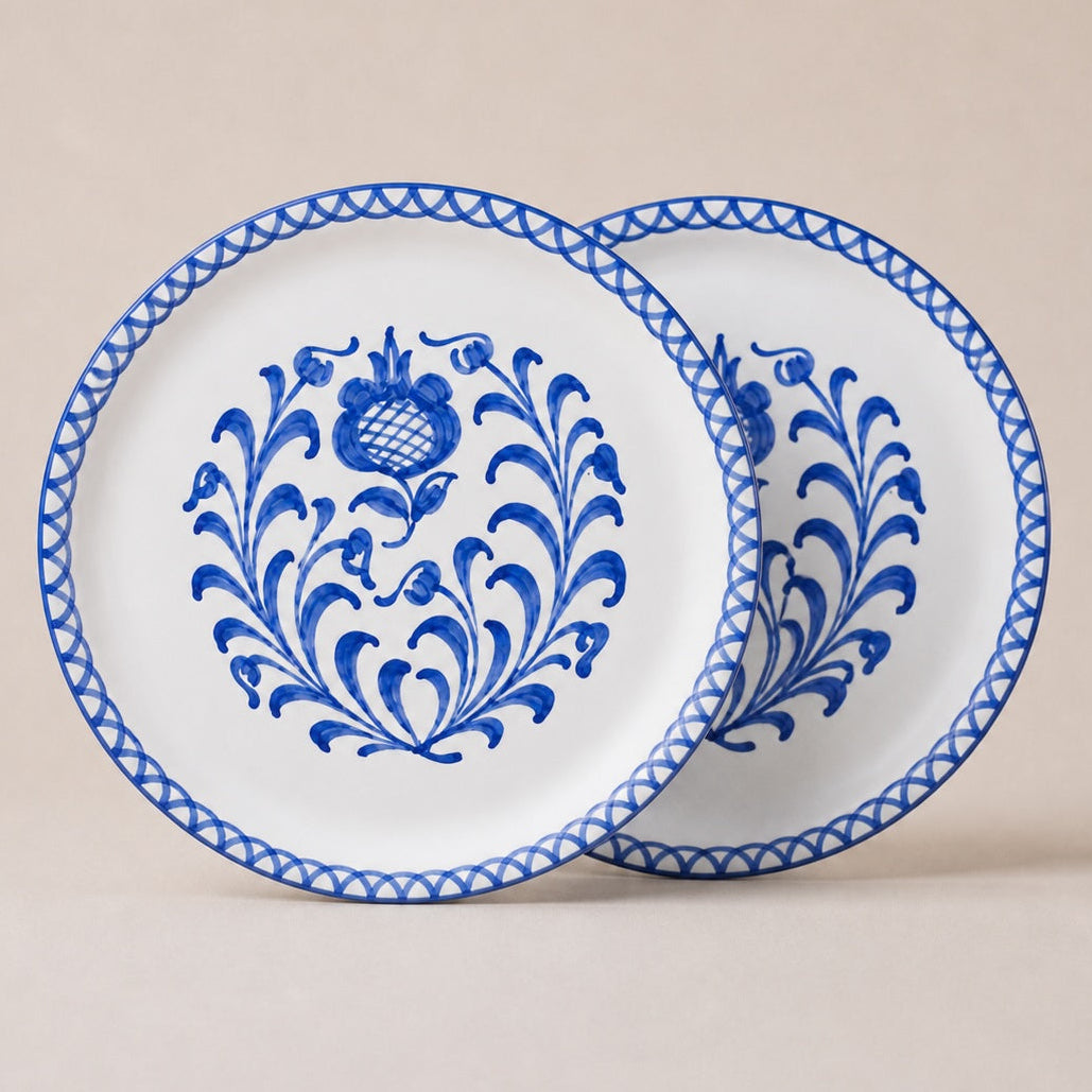 Two traditional dinner plates with blue floral patterns on a beige background
