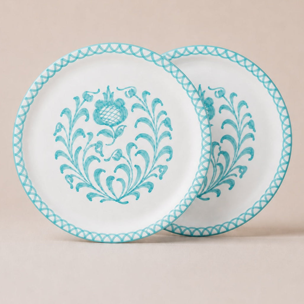 Two traditional dinner plates with blue floral patterns on a beige background