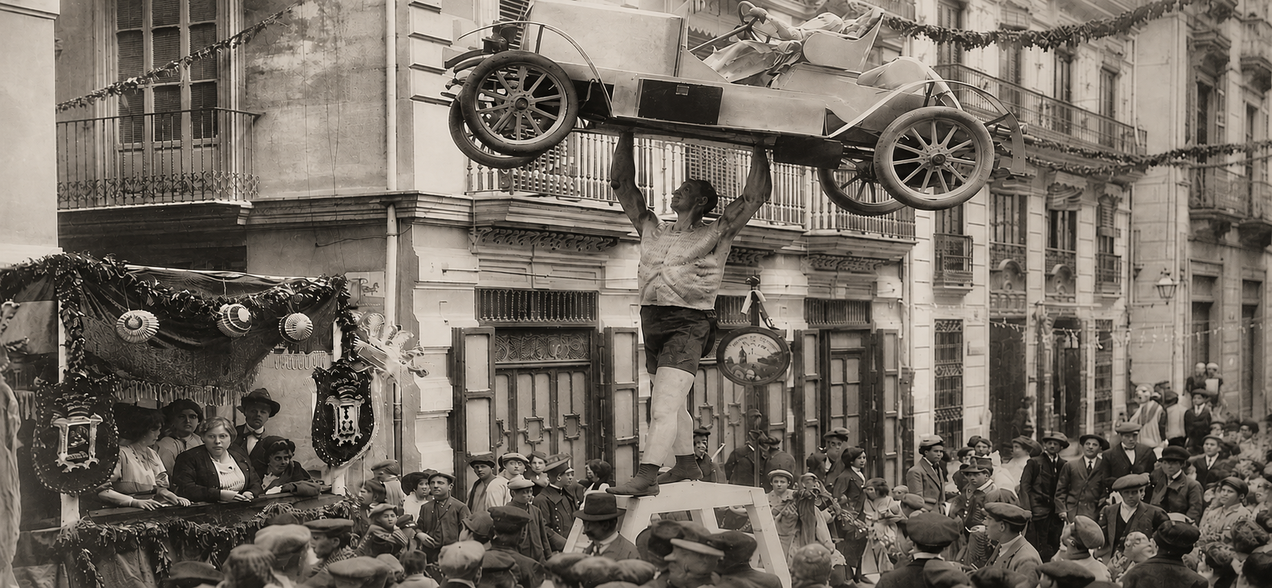 Vintage black and white photograph of a car being lifted by a crowd in a street celebration.